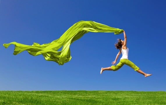 Woman Jumping on a Green Meadow with a Green Cloth - Photo courtesy of ©iStockphoto.com/erikreis, Image #12345727